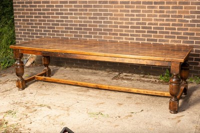 Lot 490 - A large refectory type dining table with adzed...