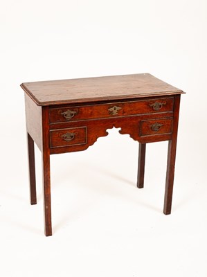 Lot 517 - A George III oak kneehole dressing table,...