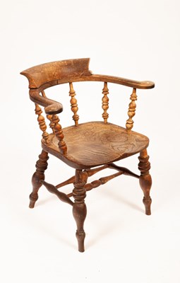 Lot 527 - An early 20th Century elbow chair with dished...