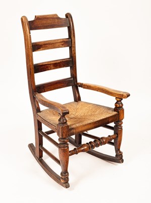 Lot 529 - A beech framed ladderback rocking chair, with...