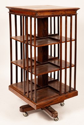 Lot 556 - A modern dark wood revolving bookcase on later...