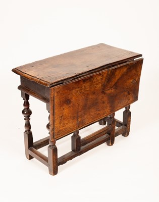 Lot 580 - A 17th Century oak gateleg table, on turned...