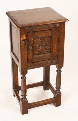 Lot 586 - An 20th Century oak pot cupboard, with carved...