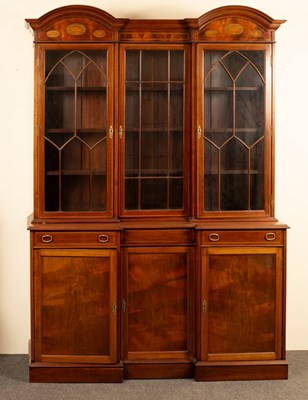 Lot 588 - A mahogany breakfront bookcase with arched top...