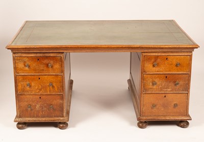 Lot 590 - A 20th Century oak pedestal desk with a green...