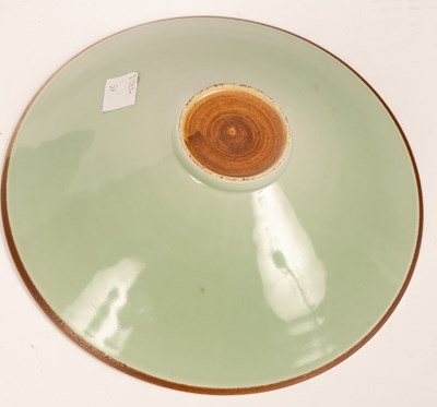 Lot 86 - A Chinese celadon dish with incised decoration,...