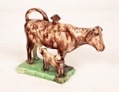 Lot 507 - An English creamware Whieldon type cow and...