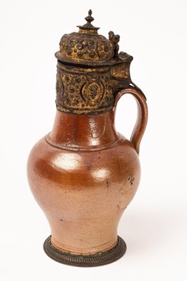 Lot 554 - A Rhineland brown salt glazed stoneware jug...