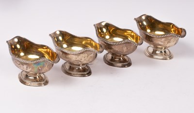 Lot 81 - A set of four George III silver and silver...