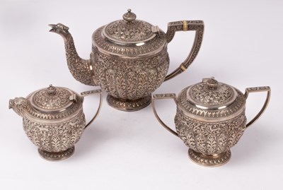 Lot 104 - A Burmese white metal three-piece tea set,...