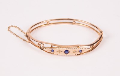 Lot 150 - An Edwardian 9ct gold hinged bangle, set with...