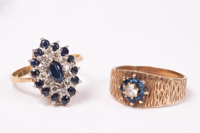 Lot 155 - A diamond and sapphire cluster ring, lozenge...