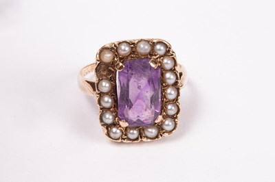 Lot 164 - An amethyst and seed pearl ring, the central...