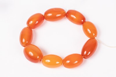 Lot 166 - An orange agate bead bracelet of nine oval...