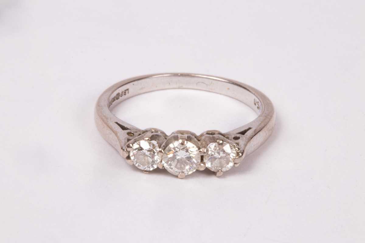 Lot 196 - A diamond three-stone ring, claw set to an...