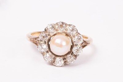 Lot 202 - A pearl and diamond cluster ring, the central...