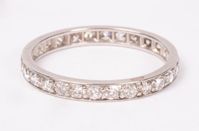 Lot 203 - A diamond eternity ring, set in white precious...