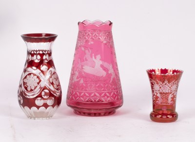 Lot 211 - A cranberry glass vase etched scenes of pixies...