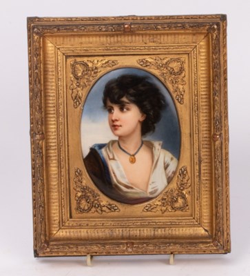 Lot 234 - A painted oval plaque of a young girl with...