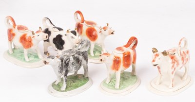 Lot 239 - A collection of six Staffordshire cow creamers,...