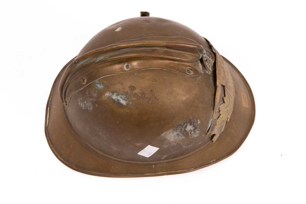 Lot 312 - A French fireman's brass helmet with crested...