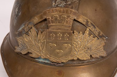 Lot 312 - A French fireman's brass helmet with crested...