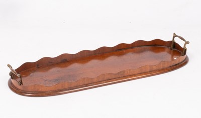 Lot 347 - An oval mahogany tray with serrated border and...