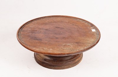 Lot 350 - A mahogany lazy Susan on a turned circular...