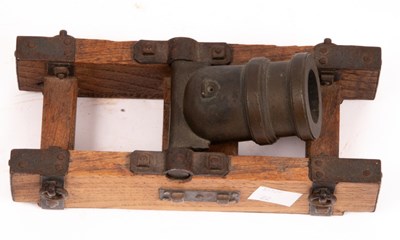 Lot 391 - A small squat cannon on a metal mounted oak...