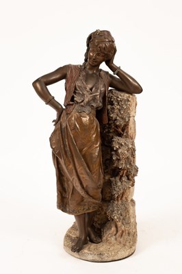 Lot 424 - A bronzed metal figure of a maiden, her left...