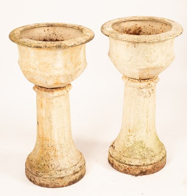 Lot 501 - A pair of cast iron garden vases on tapered...