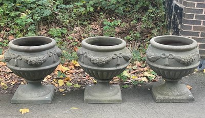 Lot 502 - Three circular moulded garden vases on...