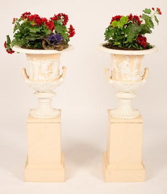 Lot 508 - A pair of cast iron urns on plinths, painted,...