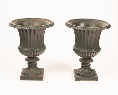 Lot 512 - A pair of cast iron urns, green painted, 60 cm...