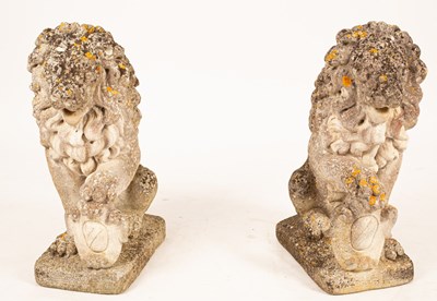 Lot 513 - A pair of composition stone models of lions,...