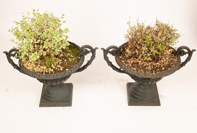 Lot 515 - A pair of green cast iron garden urns with...