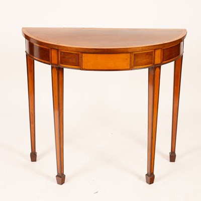 Lot 555 - A mahogany half-round hall table, banded in...