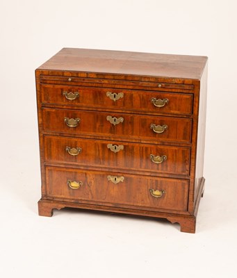 Lot 559 - A George III walnut chest, the top crossbanded...