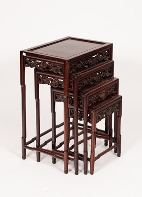 Lot 564 - A nest of four Chinese hardwood tables, each...