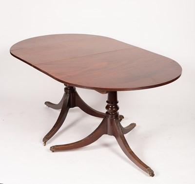 Lot 566 - A mahogany twin-pedestal dining table, fitted...