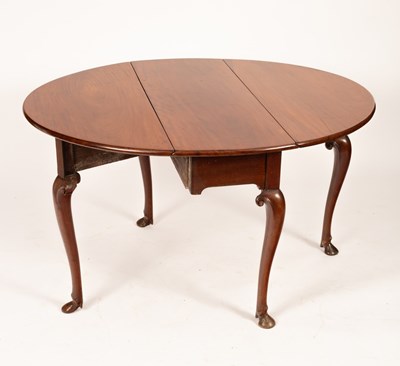 Lot 582 - A George III mahogany oval two-flap table on...