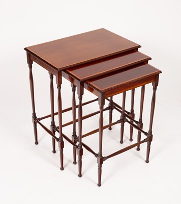 Lot 591 - A nest of three mahogany tables, crossbanded...