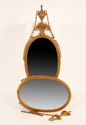 Lot 603 - A pair of oval gilt framed mirrors, surmounted...