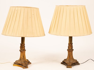 Lot 615 - A pair of gilt brass table lamps of column...