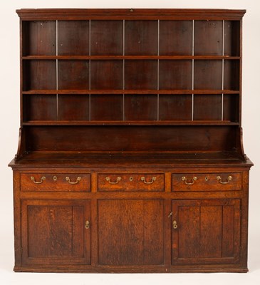 Lot 621 - A Georgian oak dresser with closed rack above...