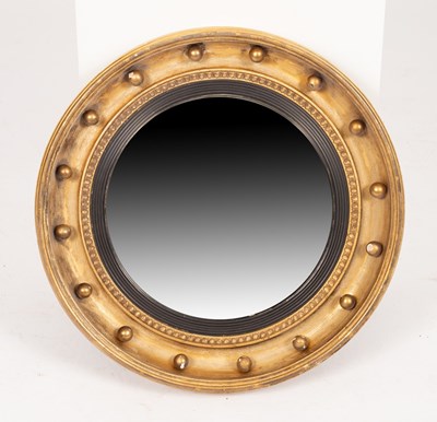 Lot 635 - A Regency gilt framed convex mirror with ball...