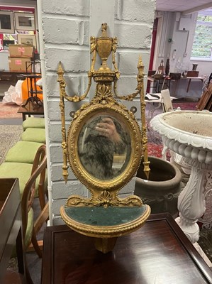 Lot 649 - A gilt wall bracket with oval mirror back