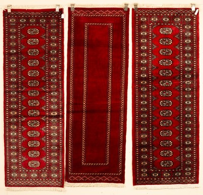 Lot 690 - Three Bokhara runners, late 20th century,...