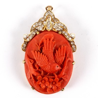 Lot 22 - A carved coral pendant of oval shape depicting...