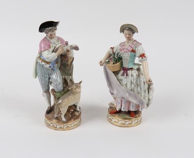 Lot 310 - Two Meissen figures, circa 1860, she holding...